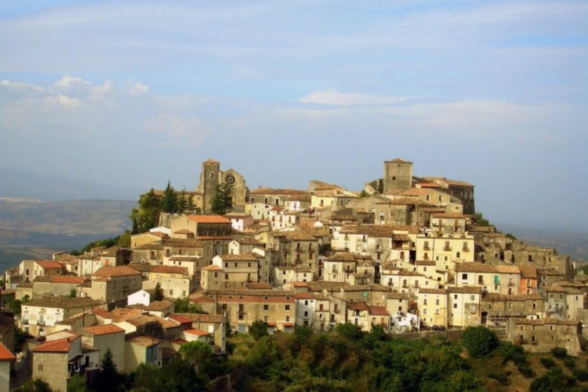 Piazza Ovidio a Tagliacozzo con la fontana al centro, circondato da edifici storici e il paesaggio montuoso sullo sfondo